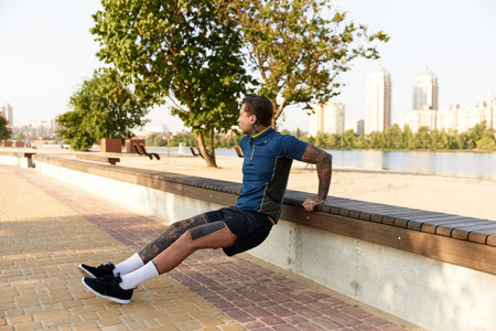 A handsome young man strolls by the riverside, enjoying scenic beauty and urban charm.の写真素材