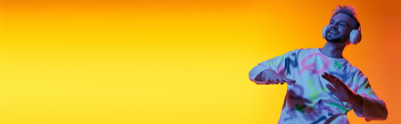 A handsome young man enjoys music while dancing, surrounded by an energetic color palette.