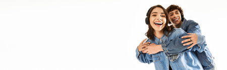 Stylish young couple enjoys a playful embrace, showcasing their love and fashion sense together.のeditorial素材