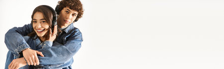 A young couple showcases their love and style while playfully interacting in fashionable denim.の写真素材