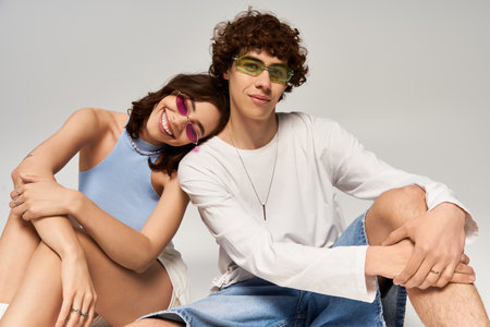 A young couple shares a fun moment, flaunting their styles and joyful connection.の写真素材