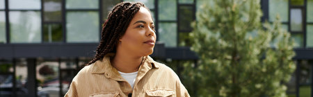 Confident teacher engages students outside a modern building, showcasing vitality.のeditorial素材