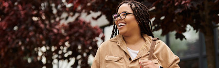 A university teacher enjoys a moment of connection with students amidst vibrant campus greenery.の写真素材