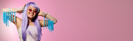 A beautiful woman with purple hair enjoys her stylish look, smiling confidently in a trendy outfit.の写真素材