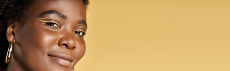 A confident young African American woman showcases flawless skin and beauty in a studio, banner