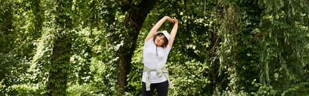 A young woman stretches in a green park, enjoying fitness and nature, banner