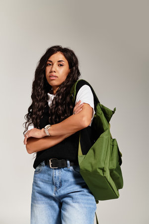 A beautiful young woman stands confidently, showcasing her student aesthetics with a trendy look.