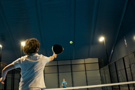 Passionate padel players showcase their skills during an engaging match on the court.の写真素材
