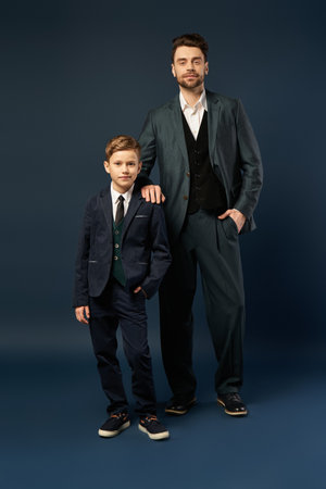 Father and son stand proudly together, embodying love and togetherness on a festive day.の写真素材