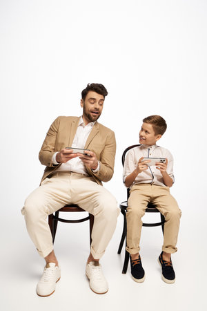 A father and son share a delightful moment gaming together, enjoying father day festivities in 2025.の写真素材