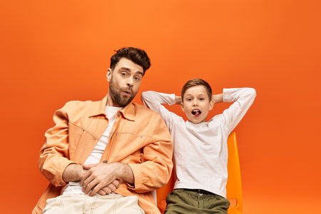 A father and son share a lighthearted moment, enjoying each others company on Father Day.の写真素材