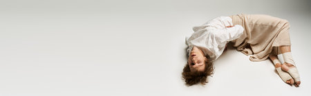 Young curly man performs an energetic dance routine in a bright studio setting, bannerの写真素材