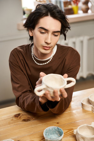 A talented man focuses on his pottery work in a creative studio filled with artistic energy.の写真素材