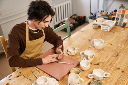 Skilled artist shapes clay into elegant forms while surrounded by handcrafted pottery tools.