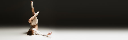 A young man showcases his athletic dance moves, embodying creativity in a studio, banner