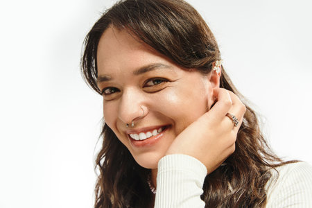 In an elegant setting, a vibrant young woman highlights her style with confidence and charm.の写真素材