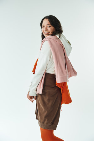 Dynamic young woman displays her flair for style, blending colors in a chic outfit with confidence.