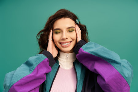 Young woman showcases her fashionable sporty look, enjoying the moment in a playful pose.の写真素材