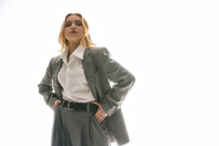 Chic young woman poses against a bright background, showcasing her unique style.