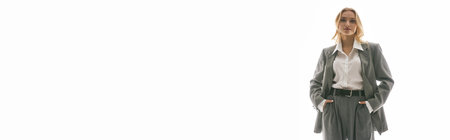 Elegant young woman in a stylish outfit stands confidently in a striking setting.の写真素材