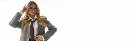 Young woman showcases her fashionable attire with confidence, expressing modern elegance and style.の写真素材