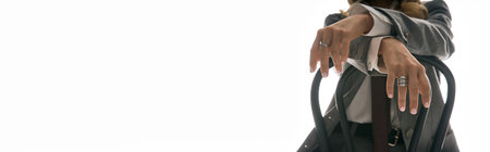 A stylish young woman poses confidently, showcasing her trendy outfit in a bright setting.の写真素材