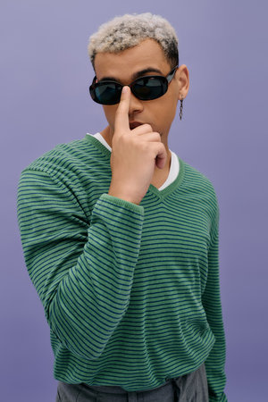 A young African American man showcases his unique fashion sense with a stylish outfit.の写真素材