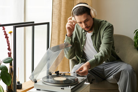 Relaxed young man listening to music on a vinyl player in a cozy home environment.