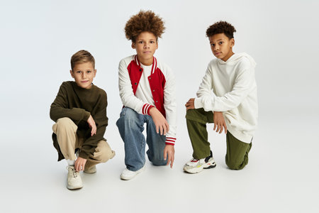 Three adorable boys display their vibrant styles while enjoying each others company and friendship.の写真素材