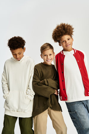 Three little boys showcase their stylish outfits while celebrating their friendship and joy.