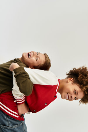Two adorable boys share a joyful moment, showcasing their vibrant outfits and strong bond.