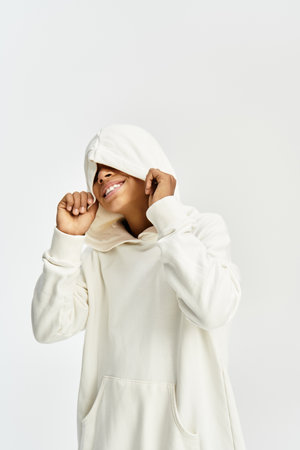 Adorable child dressed in a vibrant hoodie and enjoying carefree playful moments with joy.