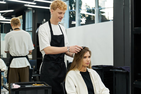 Stylists engage with clients in a vibrant beauty salon emphasizing current trends in hairstyles.の写真素材