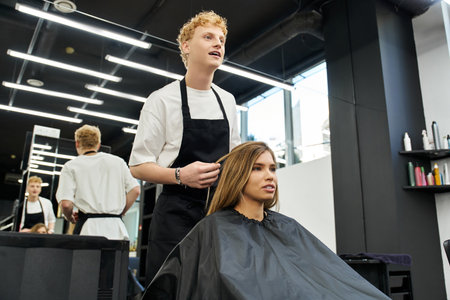 A skilled stylist is giving a trendy hair makeover to a client in a chic salon setting.