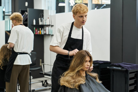 Hair stylist expertly creates a trendy look for a client in a chic beauty salon atmosphere.の写真素材