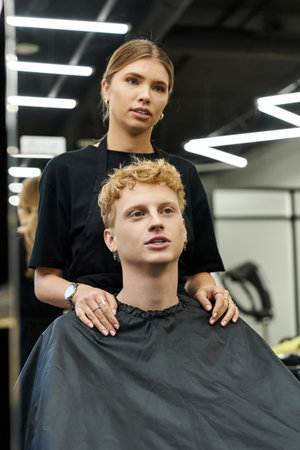 Stylists work their magic in a vibrant beauty salon, showcasing the latest trends and styles.の写真素材