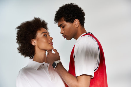 A fashionable couple gazes lovingly into each others eyes, exuding romance and style.