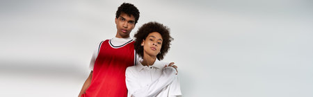 Stylish young couple showcasing their love while posing together in a minimalist space.