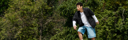A young man skillfully skates on a fresh green lawn in a vibrant park setting.