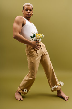 A young, handsome man with dyed hair poses confidently in a tank top and floral accents.の写真素材