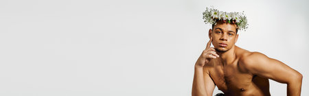 Shirtless young man showcases his beauty and confidence in a bright studio, bannerの写真素材