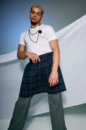A confident young man poses in unique attire, blending styles with dyed hair and bold choices.