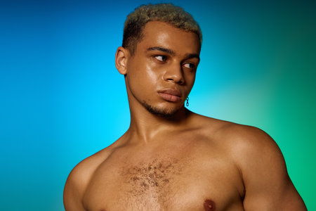 A shirtless young man exudes confidence with his dyed hair and strong physique in a studio.