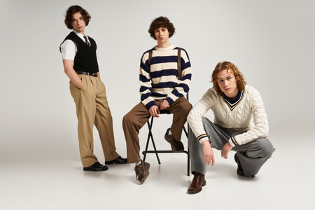 Three fashionable young men pose together, expressing their unique styles in a contemporary space.