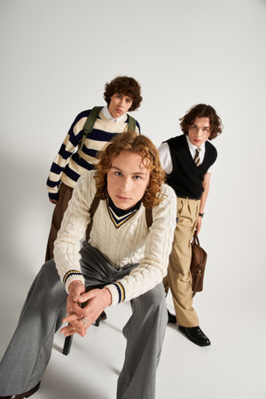 Three young men express individuality and friendship through vibrant styles in a chic studio.
