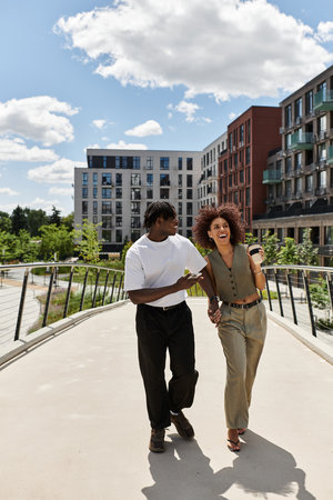 Joyful young couple in stylish attire share a delightful moment in the city during summer.
