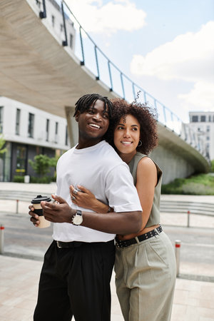 Stylish young couple revels in each other's company while exploring an urban setting.の写真素材