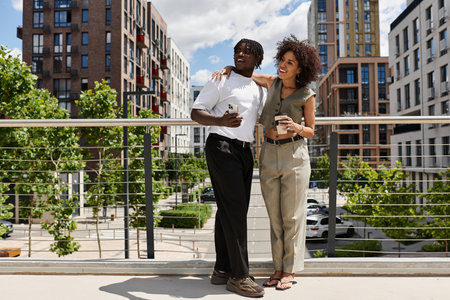 Stylish young couple enjoys each other's company while exploring the lively city streets together.の写真素材