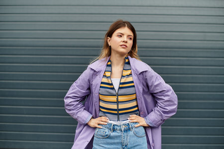 Beautiful woman poses confidently in a trendy outfit, exuding youthful energy and style.の写真素材