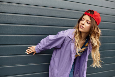 A young woman with gorgeous hair enjoys summer while playfully engaging with her surroundings.の写真素材
